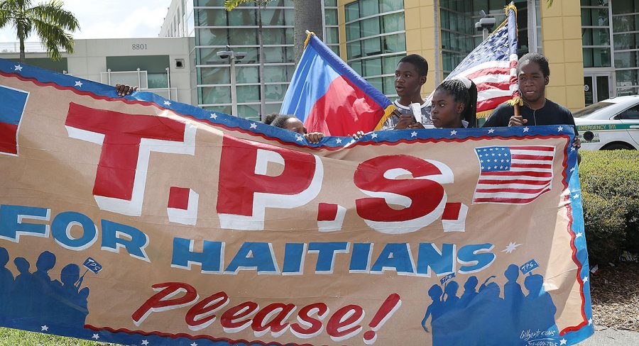 MIAMI, FL - MAY 13:  People protest the possibility that the Trump administration may overturn the Temporary Protected Status for Haitians in front of the U.S. Citizenship and Immigration Services office on May 13, 2017 in Miami, Florida.  50,000 Haitians have been eligible for TPS and now the Trump administration has until May 23 to make a decision on extending TPS for Haitians or allowing it to expire on July 22 which would mean possibly deportation for the current TPS holders.  (Photo by Joe Raedle/Getty Images)